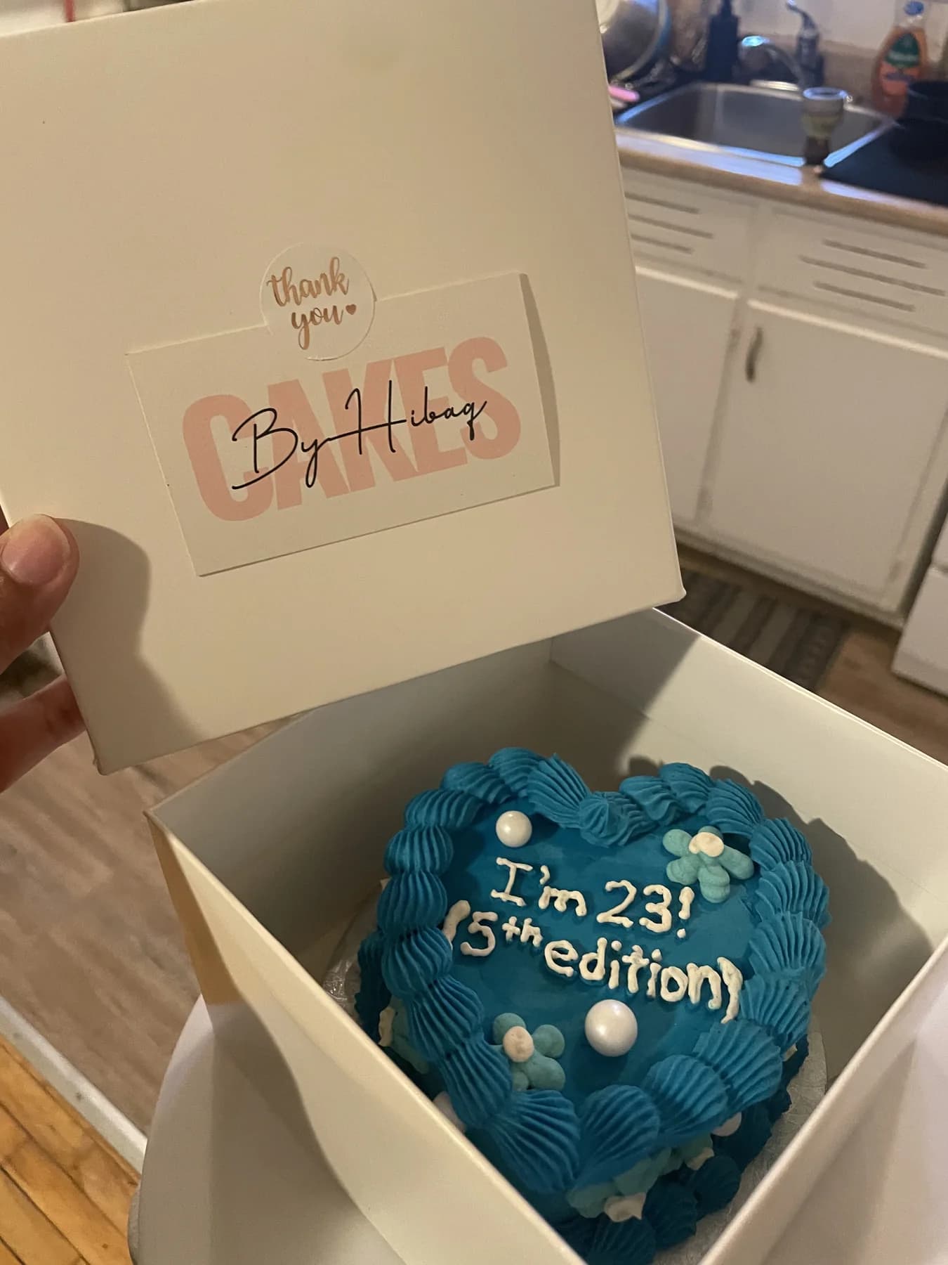 Deep blue bento cake boxed with a Cakes by Hibaq thank-you card