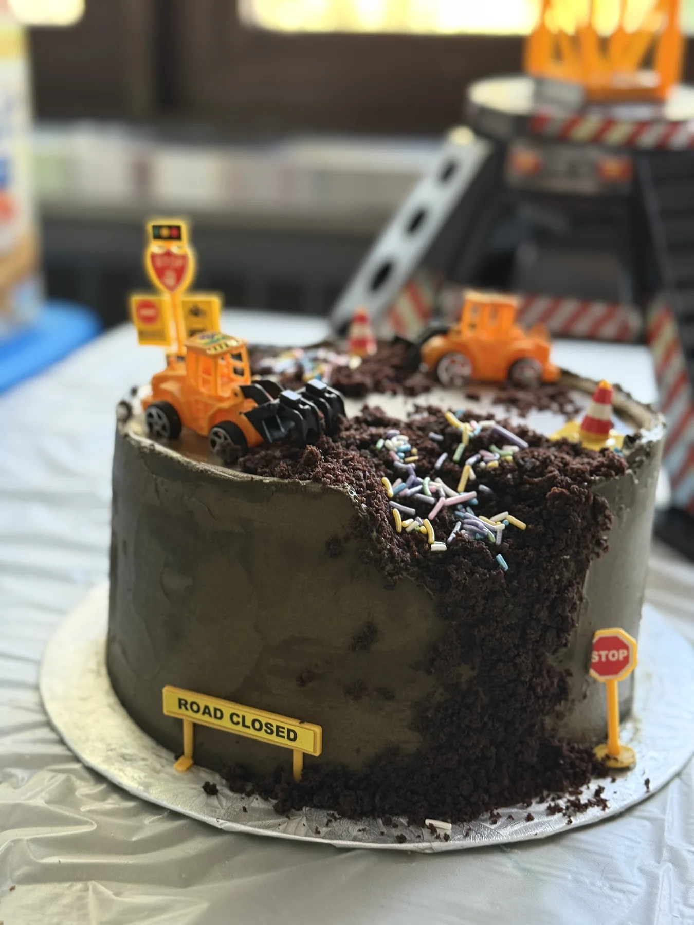 Construction-themed chocolate cake with toy trucks and crumb texture